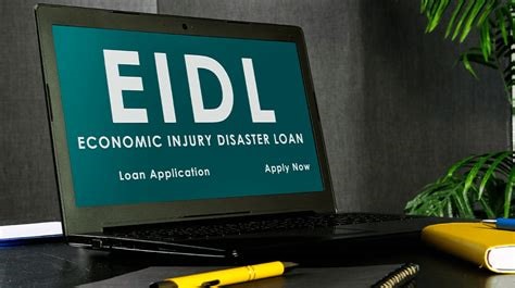 A laptop displaying 'EIDL: Economic Injury Disaster Loan' on a desk with office supplies, symbolizing how EIDL loans can be used for technology updates to support business growth.